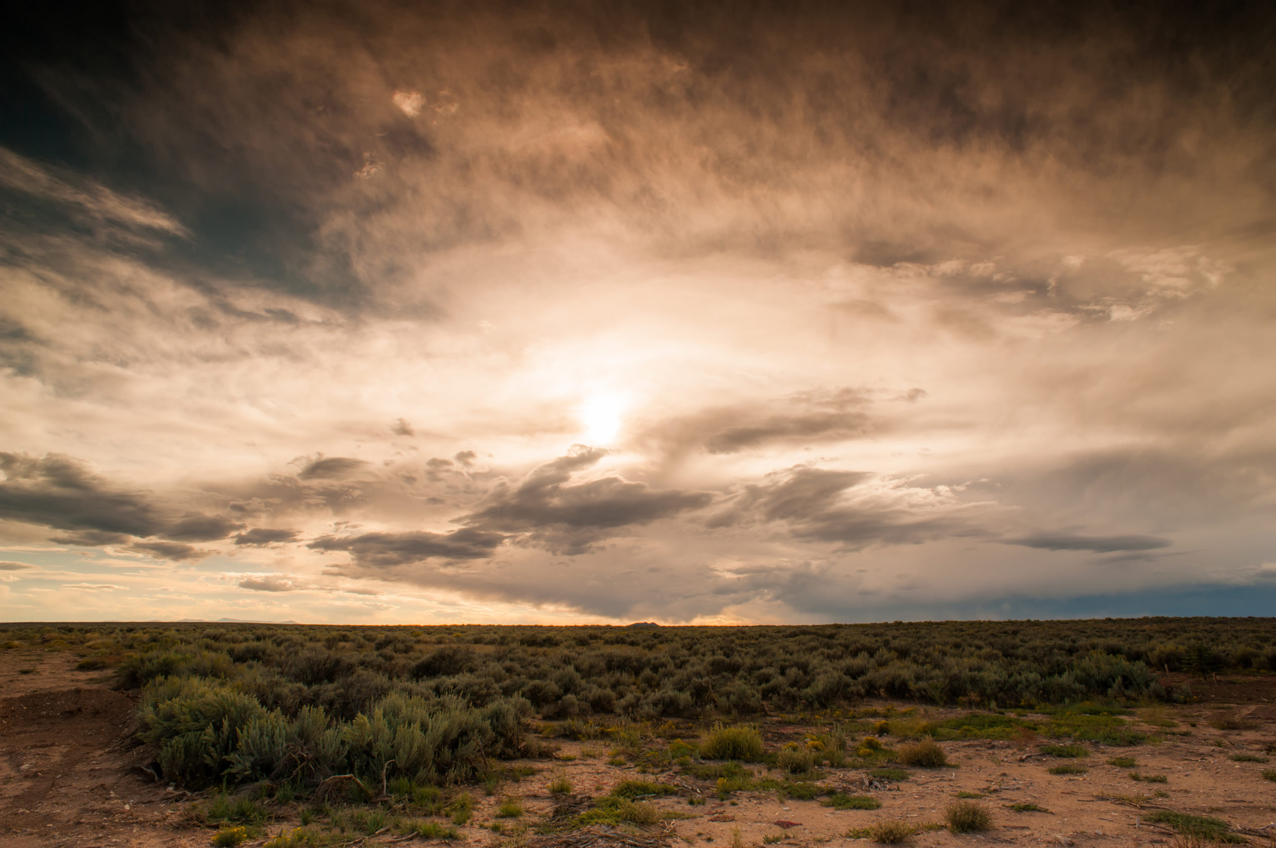 scenic photo of sunset over the Santa Fe desert and scrub brush