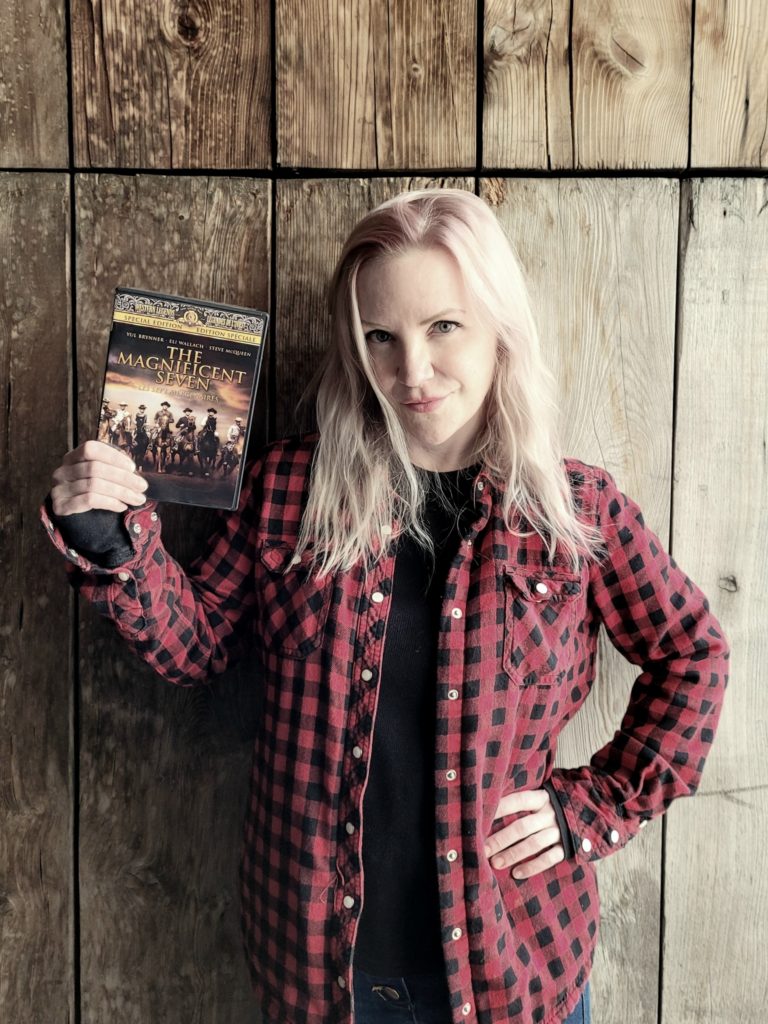 photo of the author, Pam Berg, holding the original Magnificent Seven DVD
