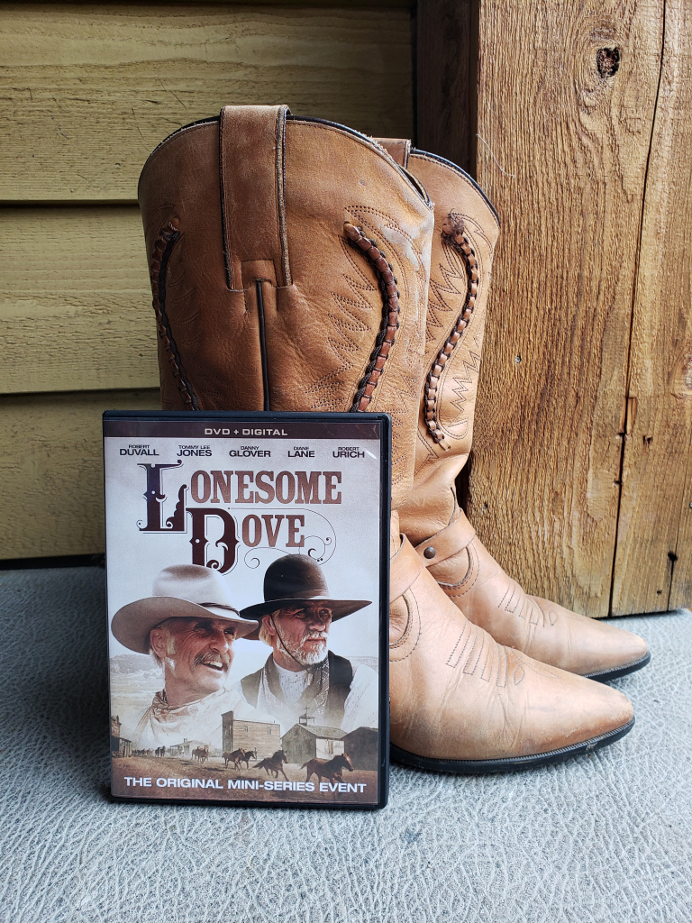 photo of the Lonesome Dove DVD next to a pair of cowboyboots