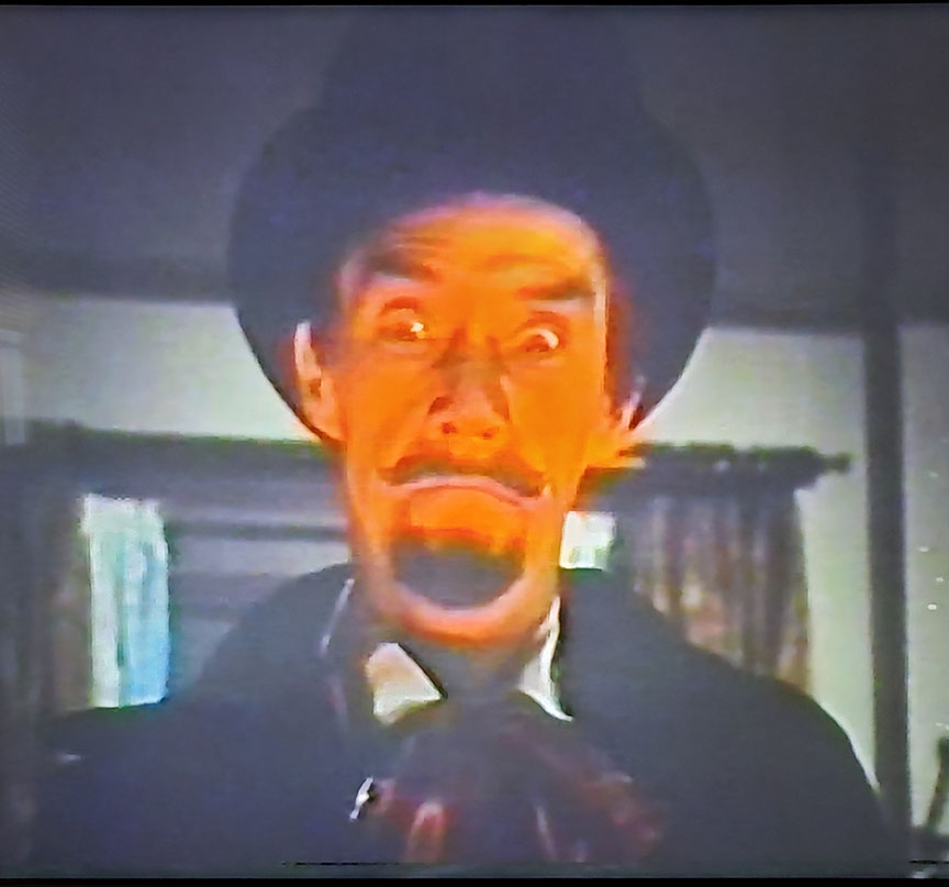 photo of John Carradine as Dracula with a very orange face