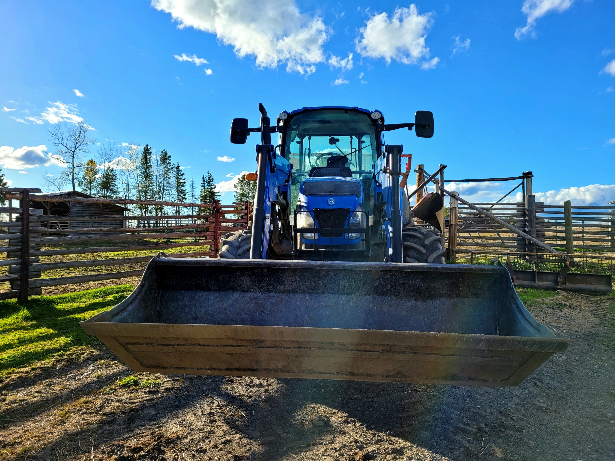 photo of a blue tractor against a blue sky