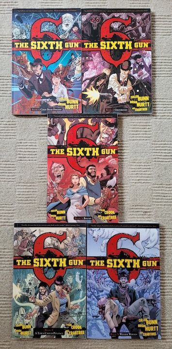 photo of five Sixth Gun comics laid out on a grey carpet