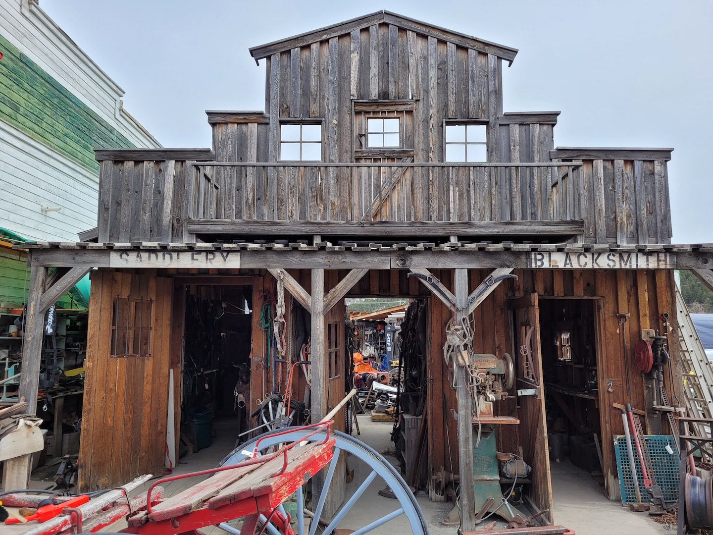 photo of the front of an historic town building in Clinton, BC, with a blacksmith and saddlery now part of an antique shop
