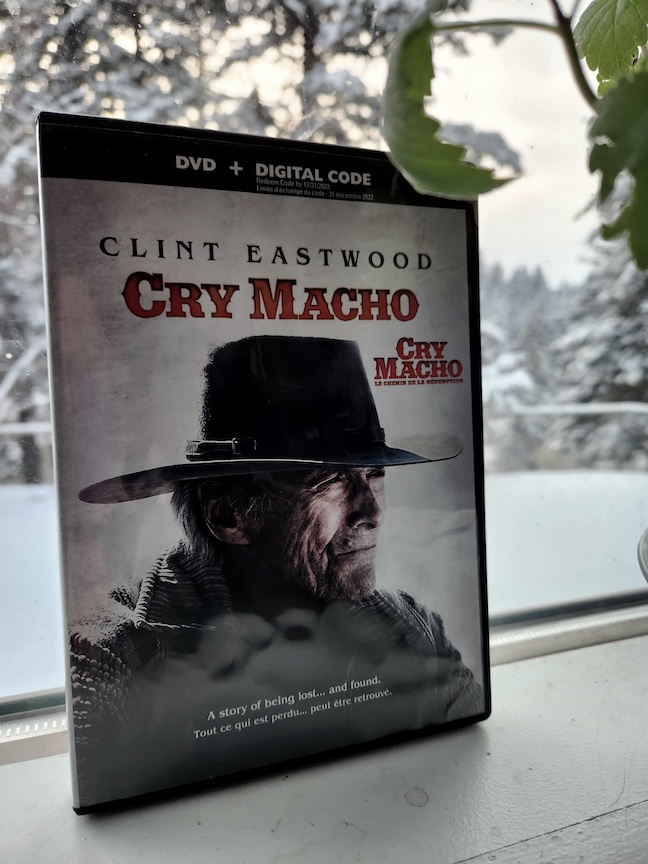 photo of the cry macho dvd against a window, snow in the background