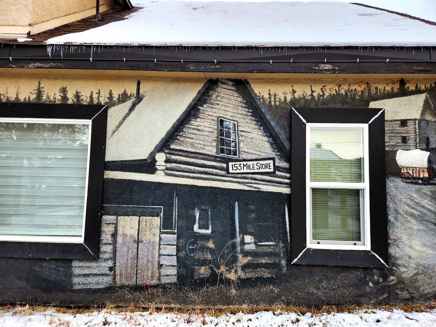 Photo of a mural on a wall in Williams Lake, depicting the pioneer building for 153 Mile Store.