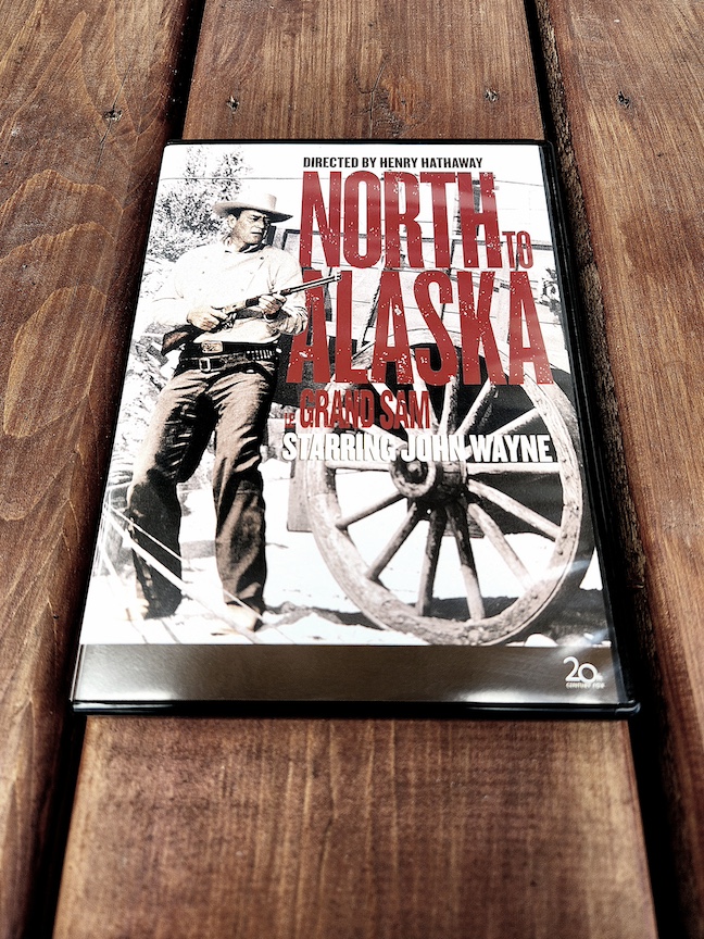 photo of the north to alaska DVD on a copper-stained wooden deck