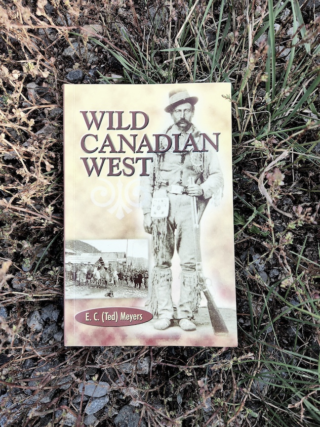 photo of the book Wild Canadian West against dirt, grass, and gavel